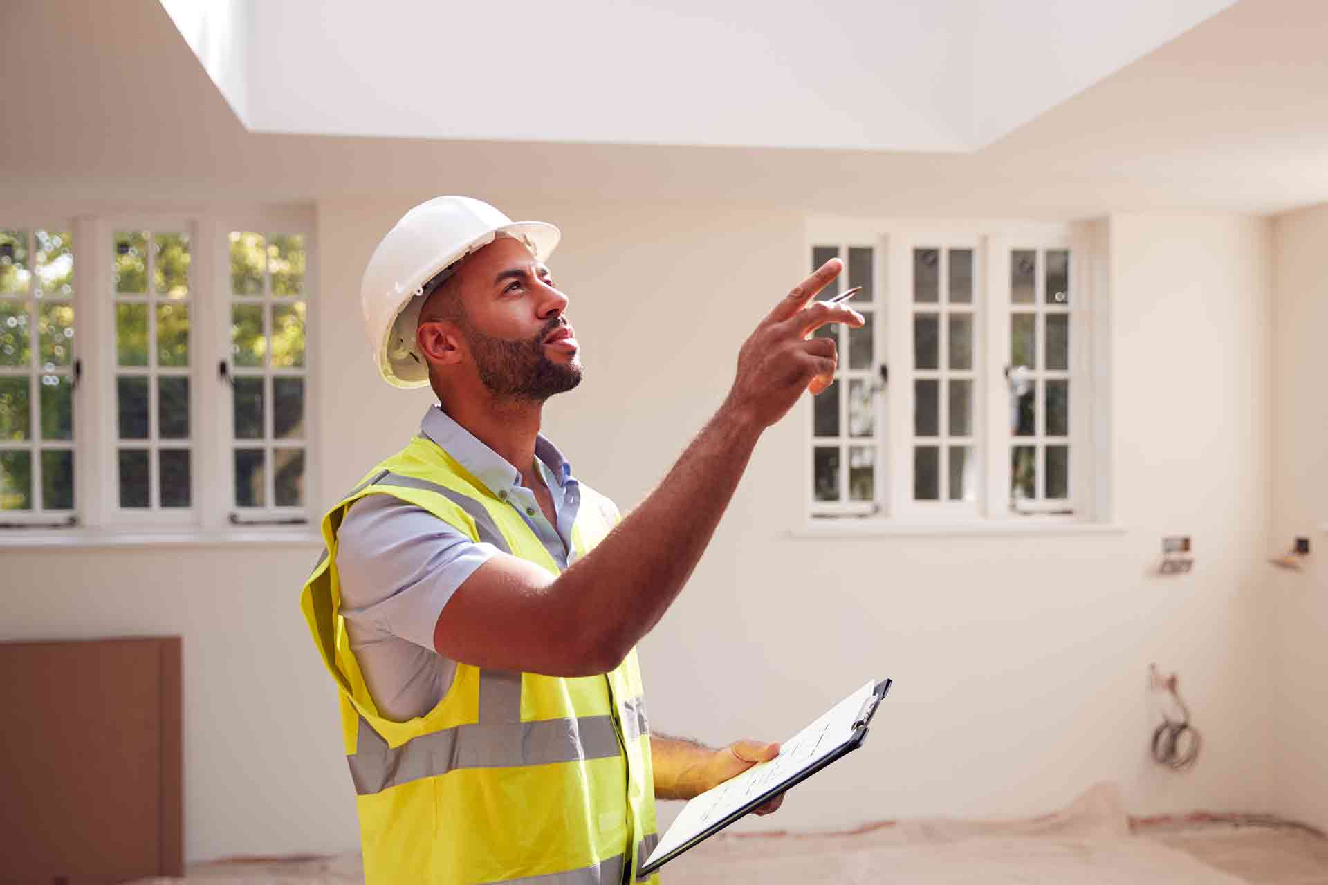 Third Party Wall Surveyors Peterborough reviewing plans between two parties during a dispute